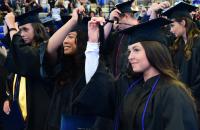 Members of the Glenville State University Class of 2022 move their tassels from right to left, signifying the completion of their degrees and their new status as alumni. (GSU Photo/Sam Santilli)