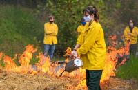 Students in the Forest Technology 214 (Fire Protection) course at Glenville State College take part in training with the West Virginia Division of Forestry to learn about controlled burns and, as pictured here, the safe use of a drip torch (GSC Photo/Kristen Cosner)