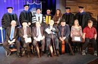 (seated, l-r) Buddy Griffin, Jesse McReynolds, Bobby Osborne, Sonny Osborne, Ronnie Reno accepting on behalf of Mac Wiseman, Jeanine McReynolds Reynolds and James Reynolds accepting on behalf of Jim McReynolds (standing, l-r) GSC Board of Governors Vice Chair Tim Butcher, GSC Board of Governors Member Mike Rust, GSC President Dr. Tracy Pellett, GSC Provost Dr. Victor Vega, GSC Bluegrass Music Program Director Dr. Megan Darby, GSC Board of Governors Member Dr. Bill Deel, GSC Board of Governors Chair Greg Smi