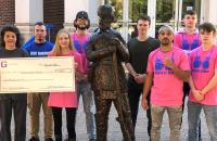American Cancer Society representative Charla Barrett (left) holds a $1,000 check presented to the American Cancer Society from members of the Glenville State College Boxing Team. The money donated was raised as part of their “Knock Out Cancer” fundraiser.