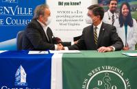 Glenville State University President Dr. Mark A. Manchin (left) and West Virginia School of Osteopathic Medicine President James W. Nemitz, Ph.D. shake hands following a recent signing ceremony welcoming Glenville State into the WVSOM Pre-Osteopathic Medicine Program. (GSC Photo/Kristen Cosner)