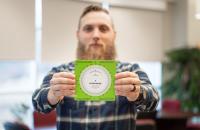 Glenville State University Lecturer of Land Surveying, Jacob Petry, holds a copy of his invention – the Pathfinder: Directional Conversion Wheel. (GSU Photo/Kristen Cosner)