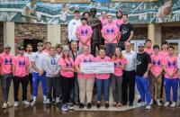 Glenville State University student athletes and members of the Athletic Training staff, Head Boxing Coach Duane Chapman, Head Wrestling Coach Dylan Cottrell, Athletic Director Jesse Skiles, and President Dr. Mark Manchin with a $2,000 check to be presented to the National Breast Cancer Foundation. (GSU Photo/Seth Stover)