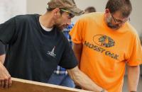 Participants inspect a board during the Lumber Grading Training workshop that was held at Glenville State University recently. The training was sponsored by the Appalachian Hardwood Training Initiative and the National Hardwood Lumber Association. (GSU Photo/Seth Stover)