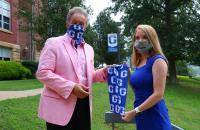 Glenville State College President Dr. Mark Manchin (left) accepts a donated face covering from Minnie Hamilton Health System Director of Business Development Brittany Frymier (right) (GSC Photo/Dustin Crutchfield)