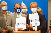 Mon Health System President and CEO, David Goldberg (left) and Glenville State College President, Dr. Mark A. Manchin are backed by members of the Glenville State Board of Governors and administration at a signing ceremony on October 20, 2021. The two signed an agreement inducting Glenville State College into the Mon Health Scholars program. (GSC Photo/Kristen Cosner)