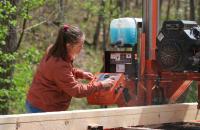 Glenville State University student Gabrielle Dean operates a portable sawmill.