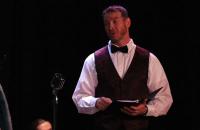 Dr. Donal Hardin at the microphone at a previous reader's theater production. The Glenville State College Players will perform Arthur Miller's All My Sons at GSC April 22-24. (GSC Photo/Kristen Cosner)