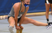 Sadie Eddins practicing straddles in a mask