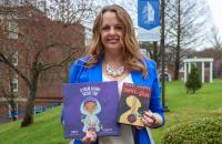 Glenville State University Associate Professor of Education and Director of Field Experiences Dr. Shelly Ratliff with copies of “Garvey in the Dark” and “A Poem Grows Inside You.” (GSU Photo/Dustin Crutchfield)