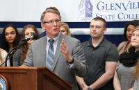 President Pellett, flanked by students, announces new initiatives to save students money at a Thursday press conference