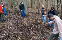 U.S. Forest Service Forester Karen Kubly (left, in orange vest) and Glenville State University student Chloe Richardson (right, holding measuring tape) take field observations with other students in the background. (Courtesy photo)