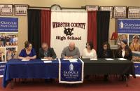 Glenville State College Provost Dr. Victor Vega (second from left) and Webster County School Schools Superintendent Scott Cochran (third from left) at the official signing ceremony