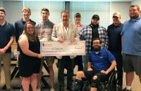 Glenville State College President Dr. Mark Manchin (center, holding check) is joined by Pioneer eSports students Aden Knopp, Adam Davis, Abigail Taylor, Noah Schultz, Justin Sodergren, Sterling Gandee, Chris Anglin, Austin Cochran and eSports Coach Logan Harrison.